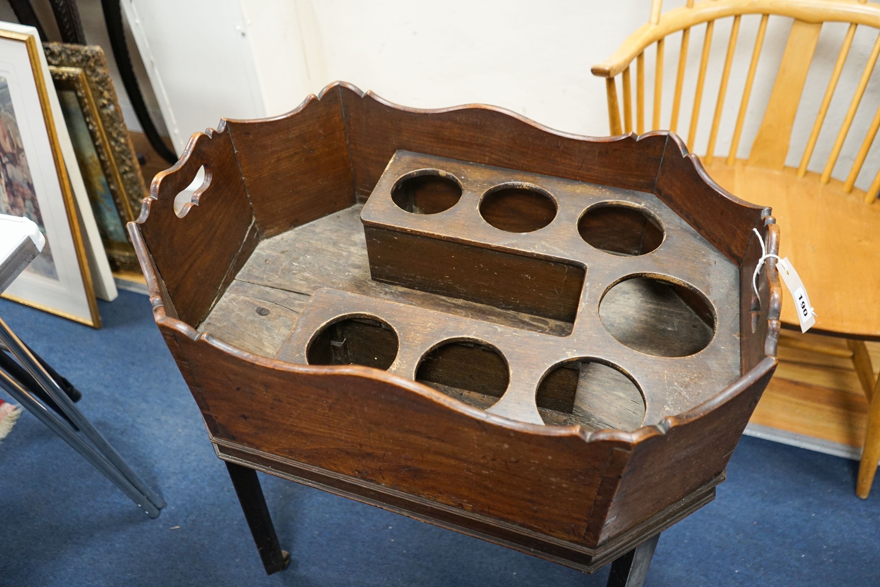 A Georgian cellarette or wine cooler of octagonal form, fitted for seven bottles, on four square legs with castors, width 66cm, depth 45cm, height 75cm
